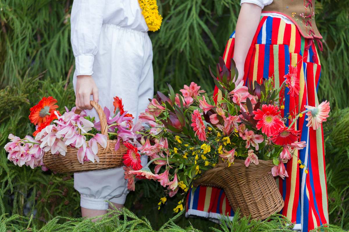 Madeirans in traditional clothes carrying baskets to flower festival © iStock
