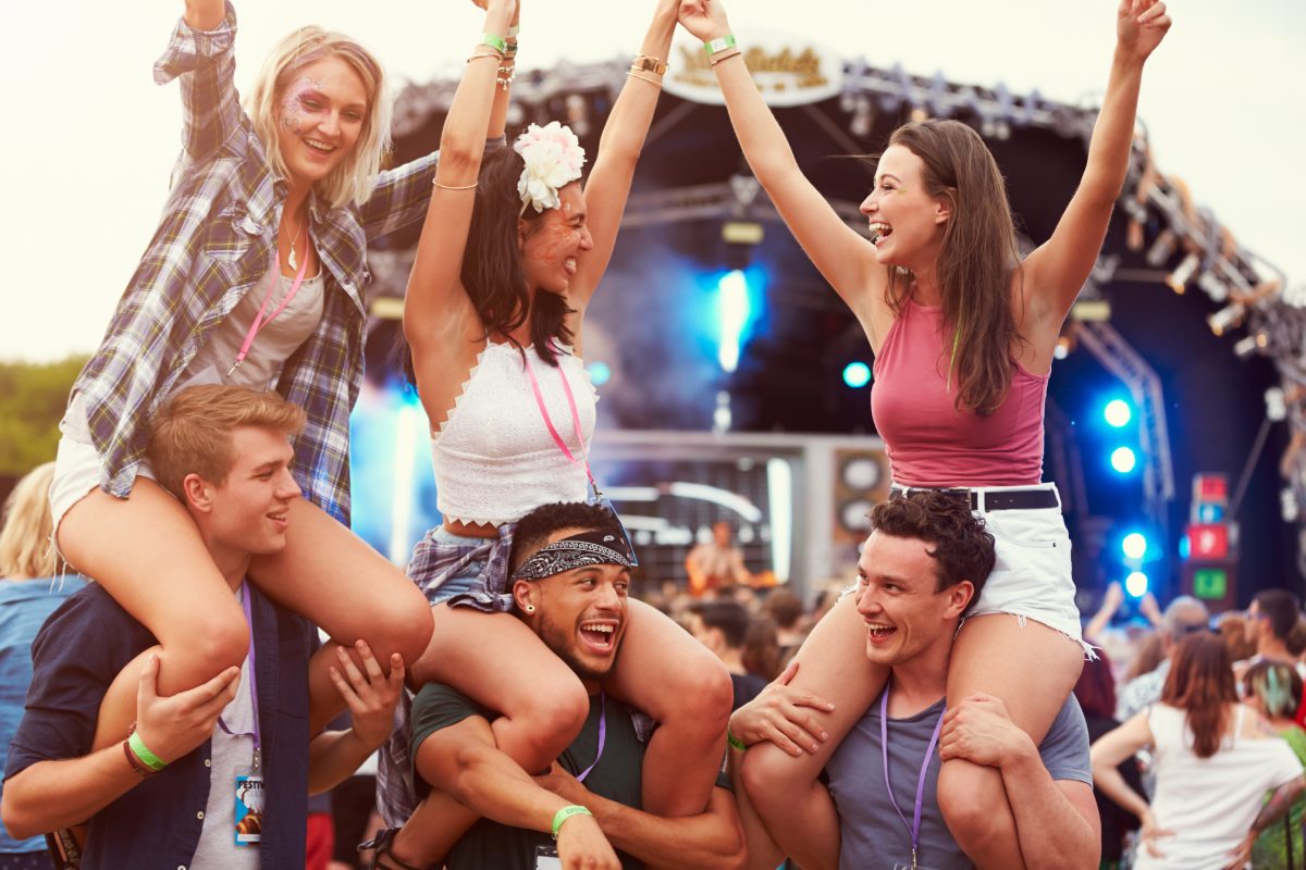 A group of friends having fun at a festival © iStock